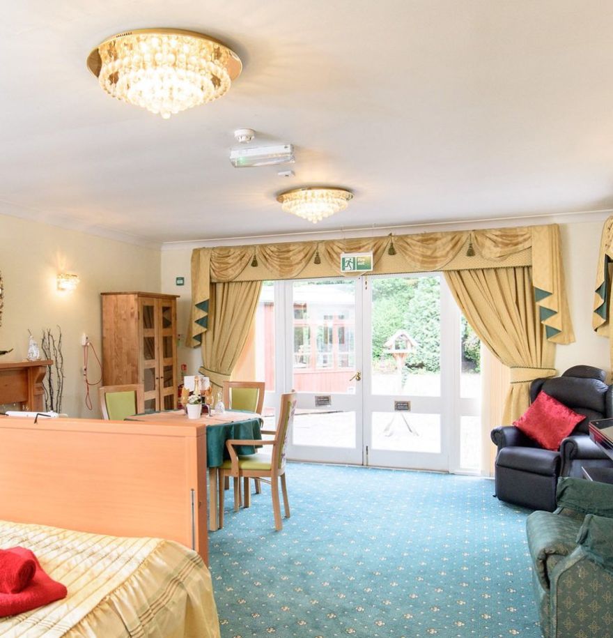 large bedroom with double doors looking into the garden