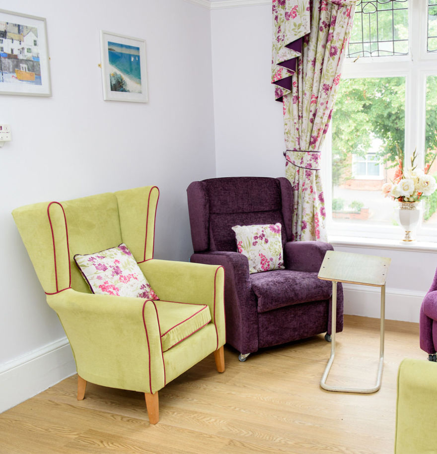 purple chair with floral cushion and green chair with floral cushion