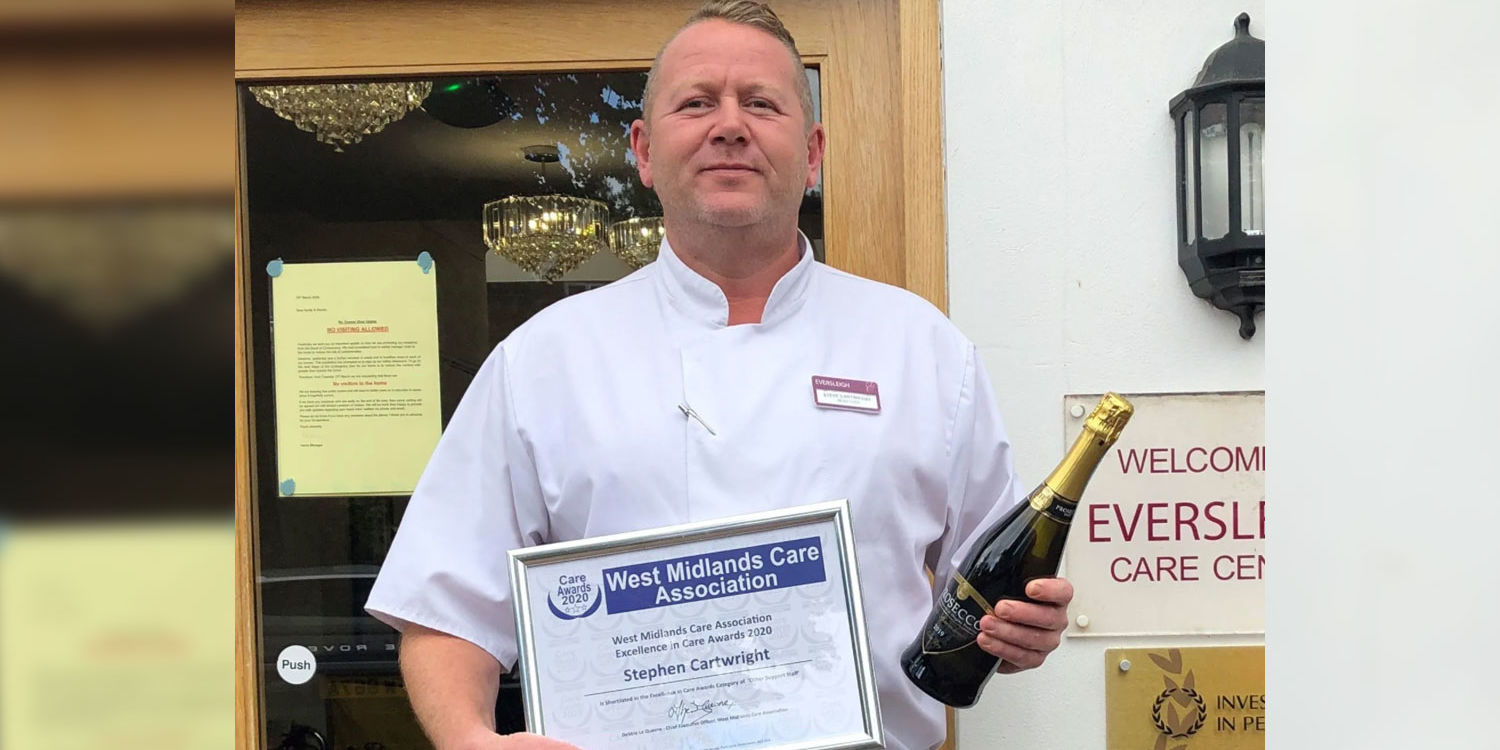 stephen cartwright holding west midlands care association certificate and champagne